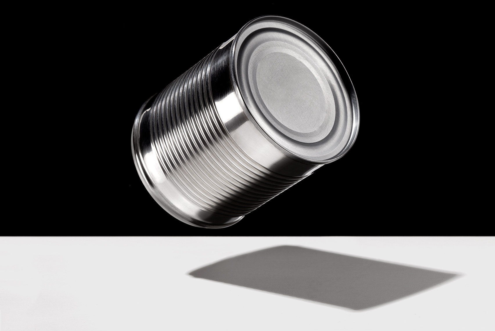 Aluminum can floating by John Kuczala