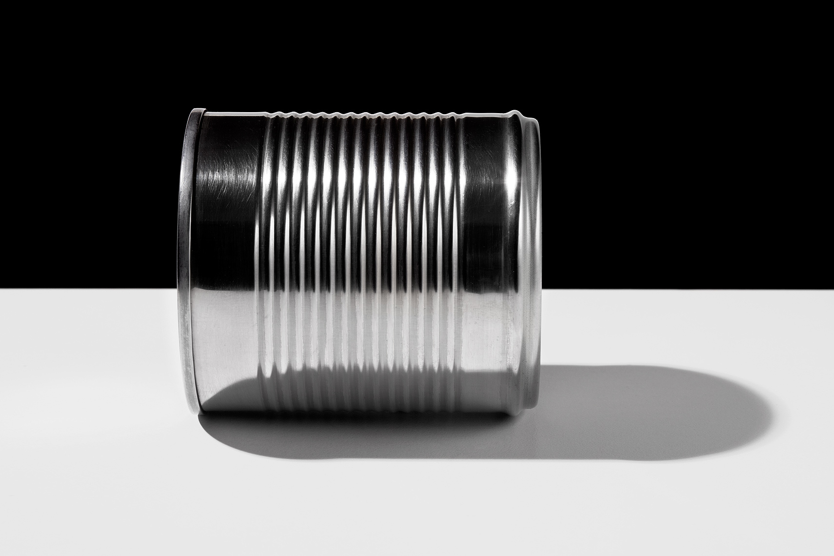Aluminum can on table side view by John Kuczala