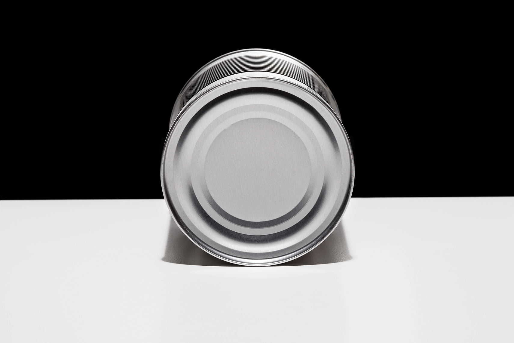 Aluminum can on table top by John Kuczala