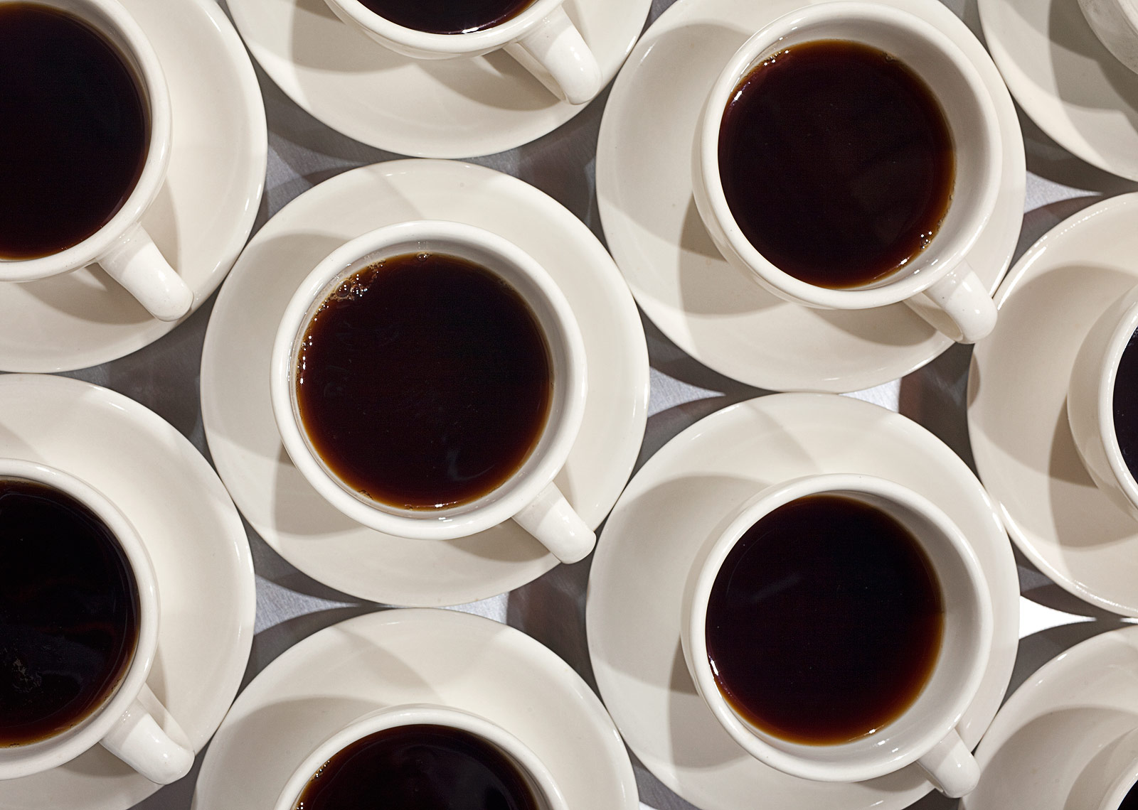 Coffee cups in a row food photography by John Kuczala