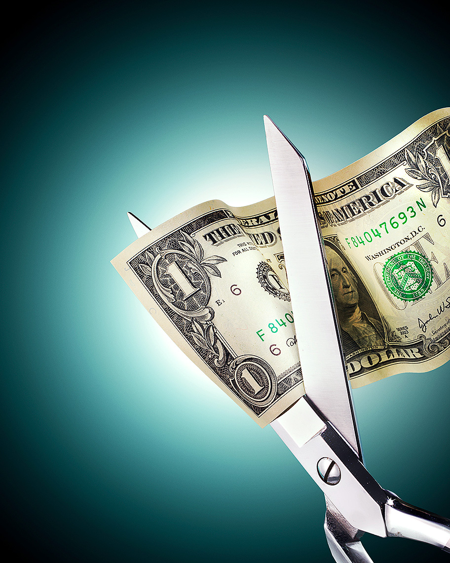Budget cut, scissors and dollar conceptual photo by John Kuczala