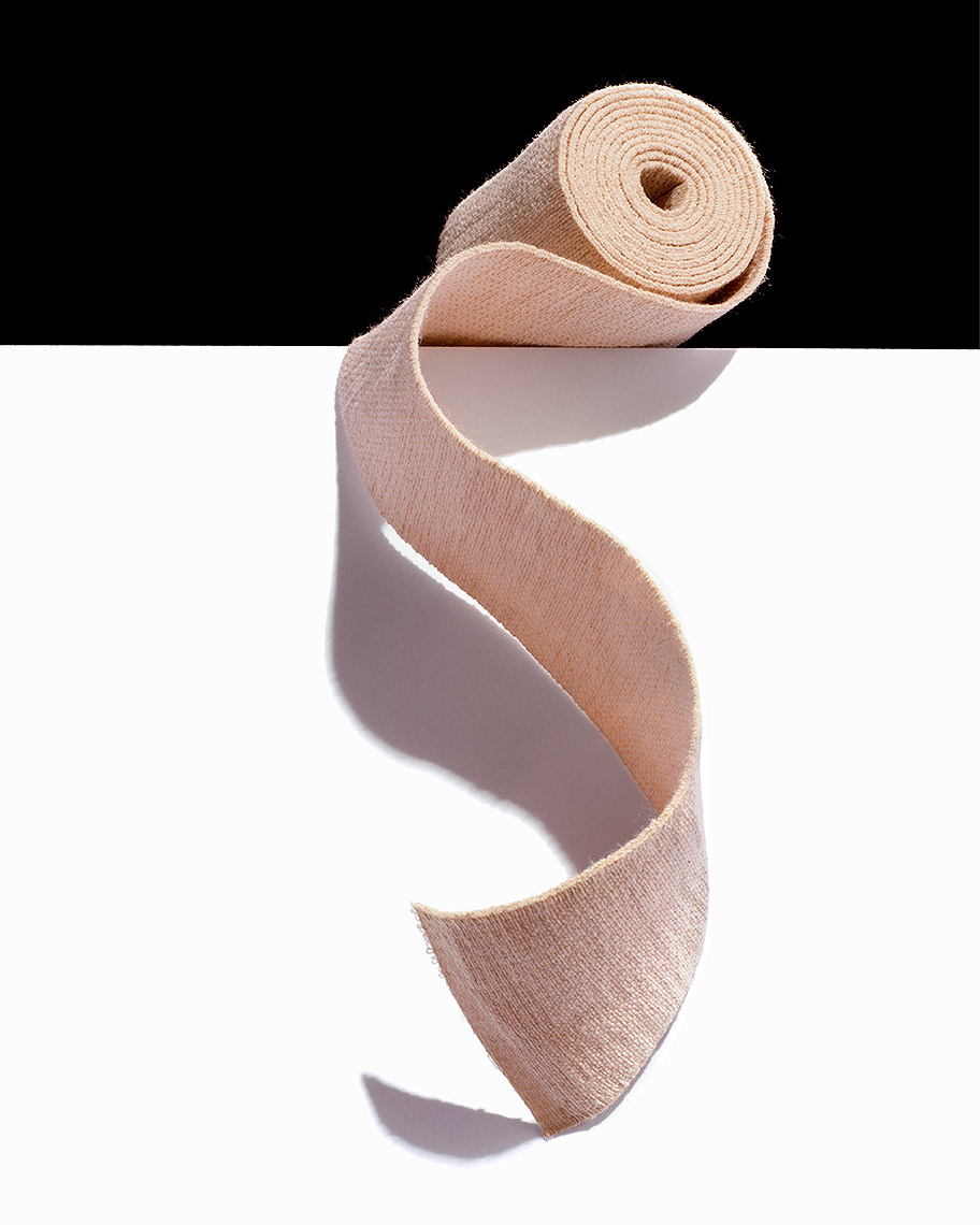 Gauze bandage unraveled on edge conceptual photo by John Kuczala