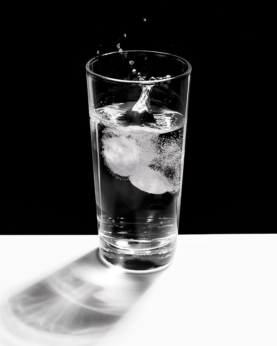 Antacid tablets in glass of water fizzing photo by John Kuczala