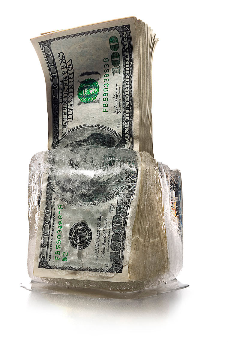 Cash freeze melting hundred dollar bills photo by John Kuczala